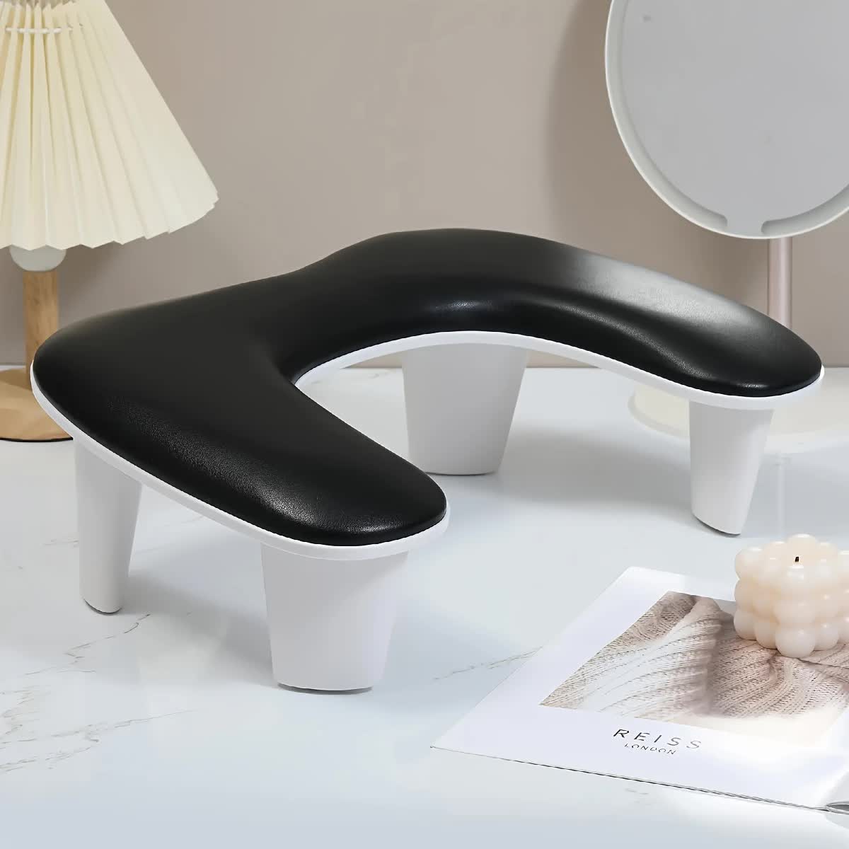 BLACK This handheld nail care device integrates a U-shaped pillow and comes with a portable detachable stand. Designed with an inclined PU material and a sturdy base, it is crafted for both comfort and portability.